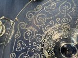 a glass plate with a design on it on a table