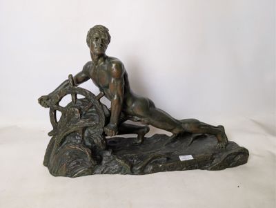 bronze statue of a woman sitting on a rock with a dog