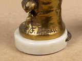 a statue of a woman with a hat on top of a table