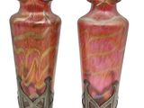 two vases sitting side by side on a white background