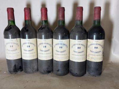 six bottles of wine are lined up in a row on a table
