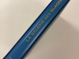 a close up of a blue book on a white surface