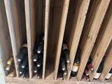 many bottles of wine in a wooden wine rack