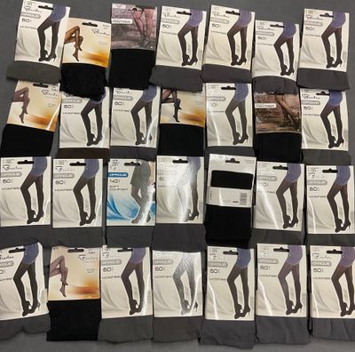 several pairs of women ' s black and white tights on a bed