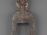 a wooden figurine of a man holding a piece of wood
