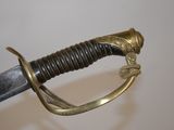 a close up of a sword with a gold handle