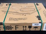 a cardboard box with a green ribbon on top of it
