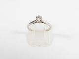 a white gold ring with a diamond set in the center