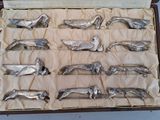 a lot of silver spoons in a box on a table