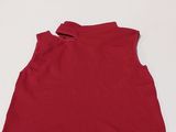 a red top sitting on top of a white table next to a pair of scissors