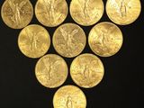 a close up of a bunch of gold coins on a black surface