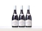 three bottles of wine sitting on top of a table next to each other