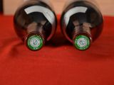 two bottles of wine that are sitting on a table
