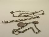 a silver chain that has a coin on it