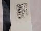 a label on a white shirt with a black tie