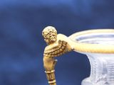 a glass vase with an angel figurine on it