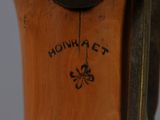 a close up of a clock on a wooden pole