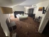 a room with a bed and a desk in it