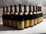 many bottles of wine lined up on a table