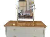 an image of a dresser with a mirror on top of it