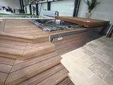 un jacuzzi au milieu d'une terrasse en bois