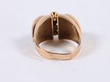a close up of a gold ring on a white surface
