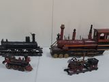 three different types of toy trains on a table