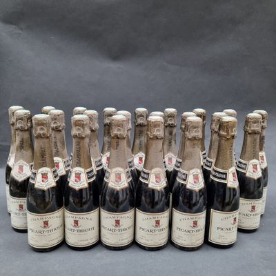 six bottles of wine are lined up in a row on a table