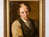 portrait d'un homme en gilet, à côté d'un tableau le représentant