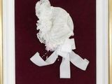 an image of a framed picture of a woman ' s head with a white ribbon