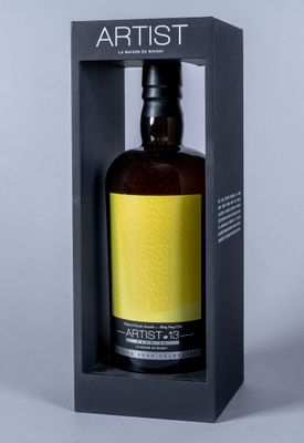 an empty bottle in a black box with a yellow label