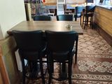two black chairs sitting at a table in the middle of a room