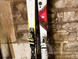 a pair of skis leaning up against a brick wall