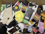 many pairs of socks in a box on the floor