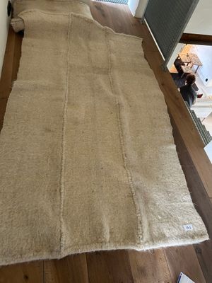 a large rug on the floor next to a laptop