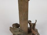 a statue of a bird sitting on top of a bird feeder