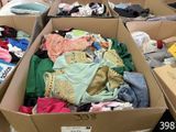 many boxes of clothes that are sitting on the floor