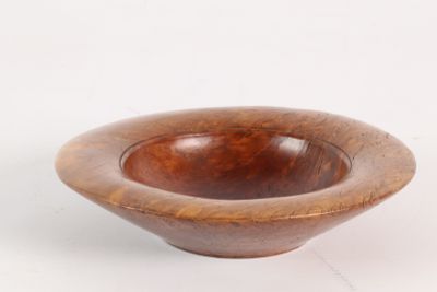 wooden bowl on a white surface with a white background