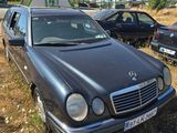 a car that is parked in the grass near other cars