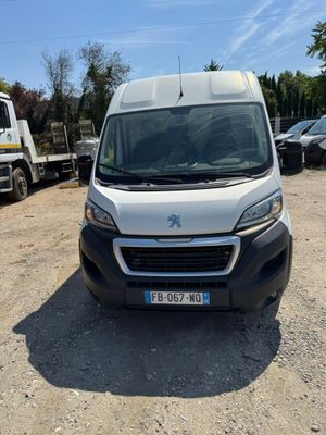 a white van parked in a parking lot next to a truck