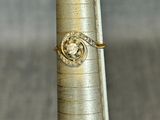 a pen with a ring on it sitting on top of a pole