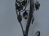 a metal lamp with a yellow glass shade hanging from it ' s side