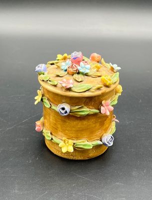 a small yellow box with flowers on it on a table