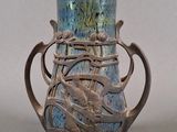a blue vase with a dragon on it sitting on a table