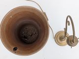 a brown bowl with a handle and a light on it