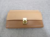 a close up of a wallet with a gold clasp on it