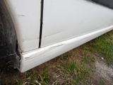 a close up of a white car with a broken door