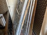 a pile of old windows in the corner of a room