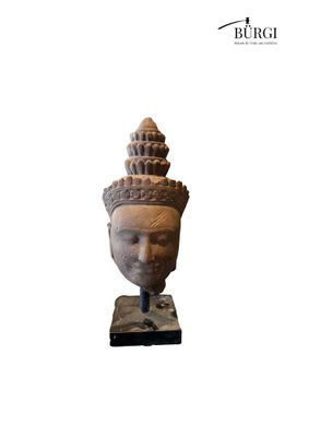 a close up of a statue of a head on a stand
