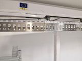 a picture of a metal shelf with a bunch of keys on it